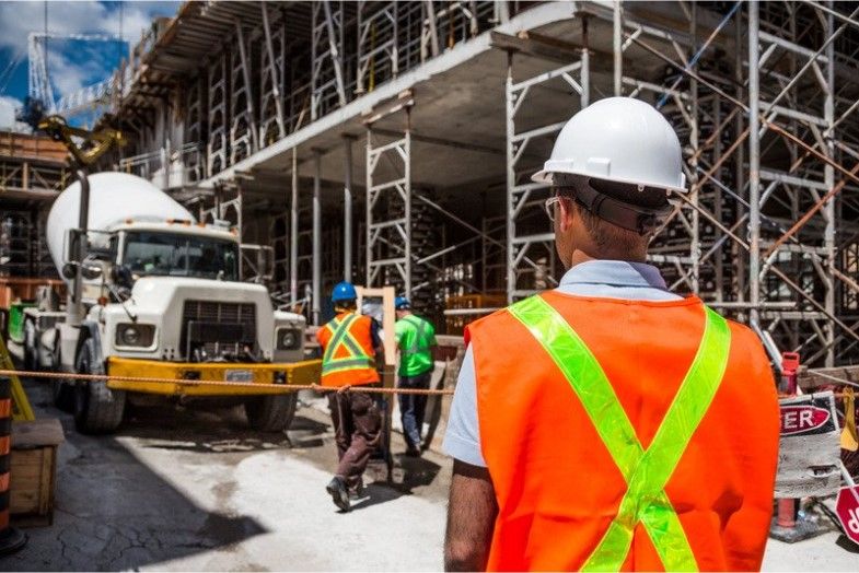 construction worker wearing safety gear and standing on construction site