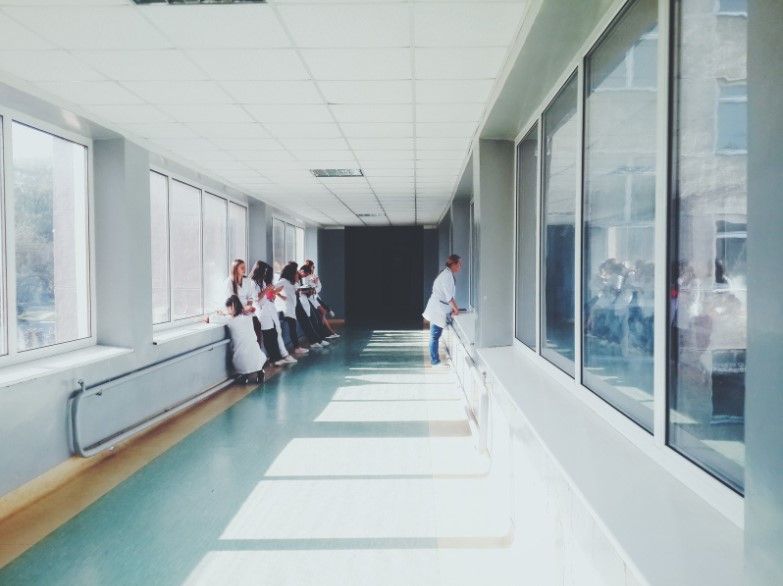 nurses and doctors standing in a hospital hallway