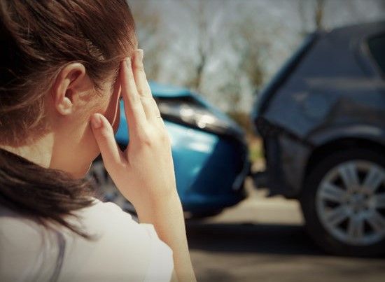 woman looking at a car accident